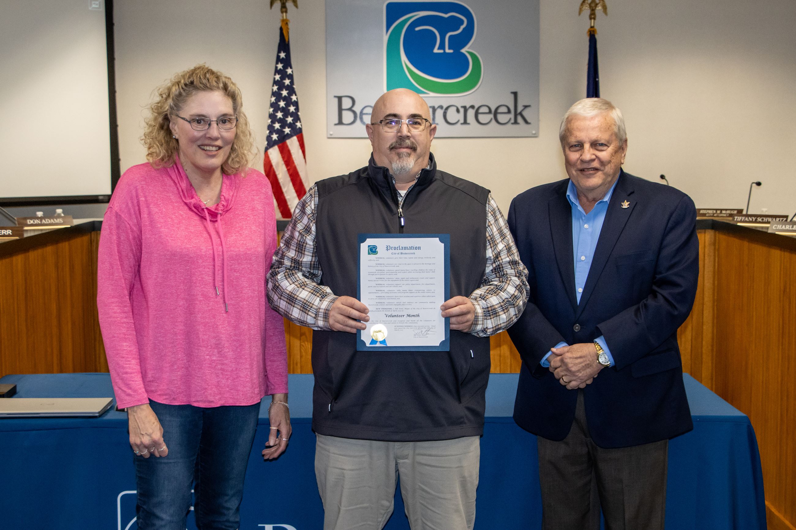 Two park volunteers and city mayor smiling 