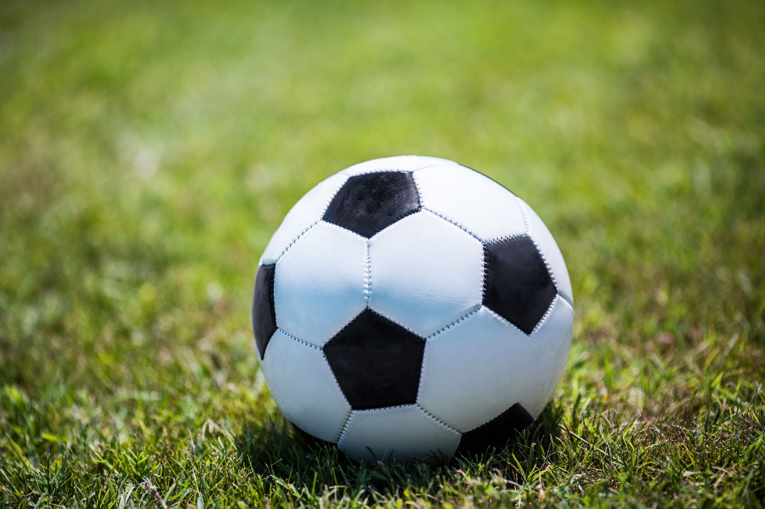 Close up of soccer ball in a grassy field