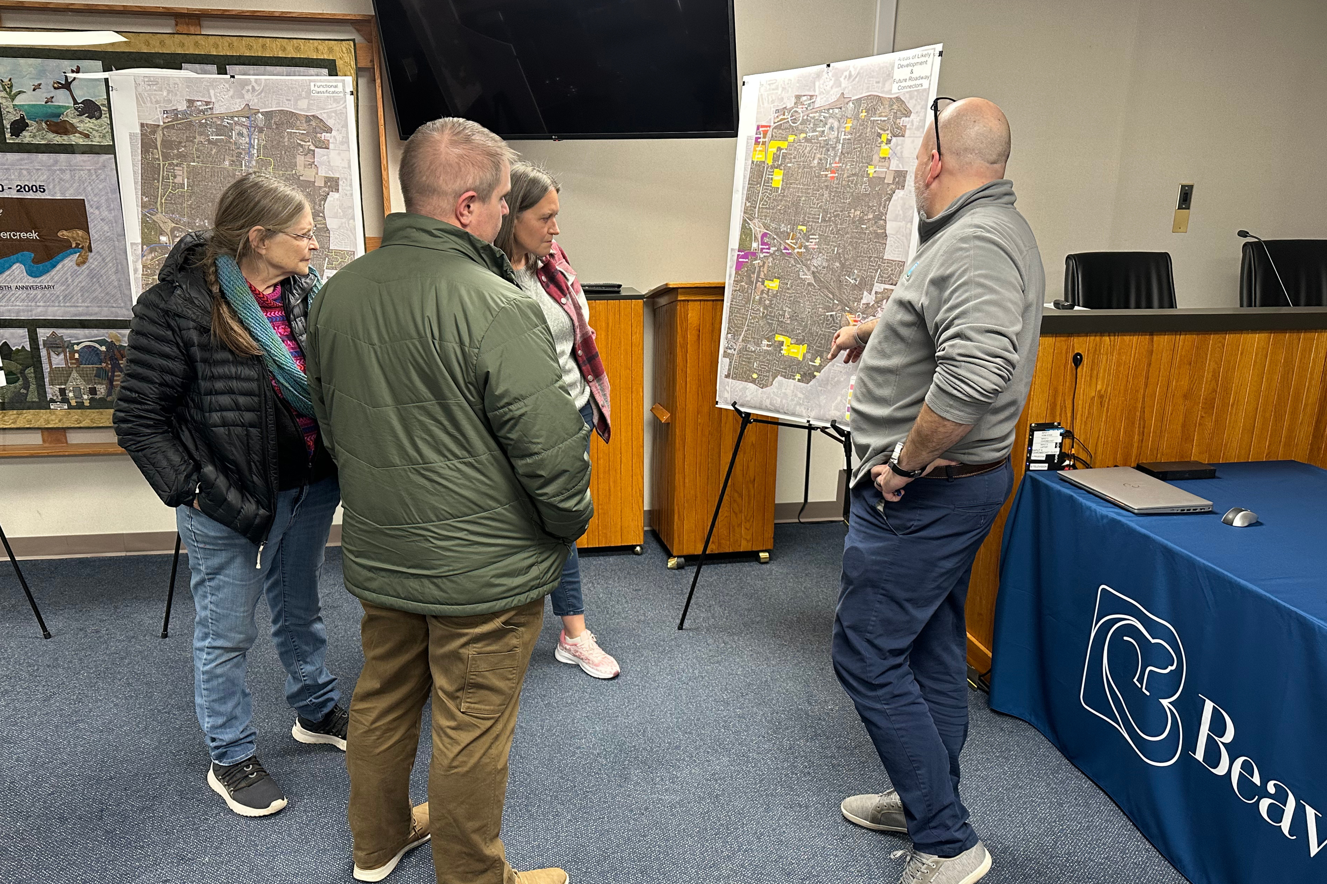 Three residents reviewing City of Beavercreek's thoroughfare plan open house