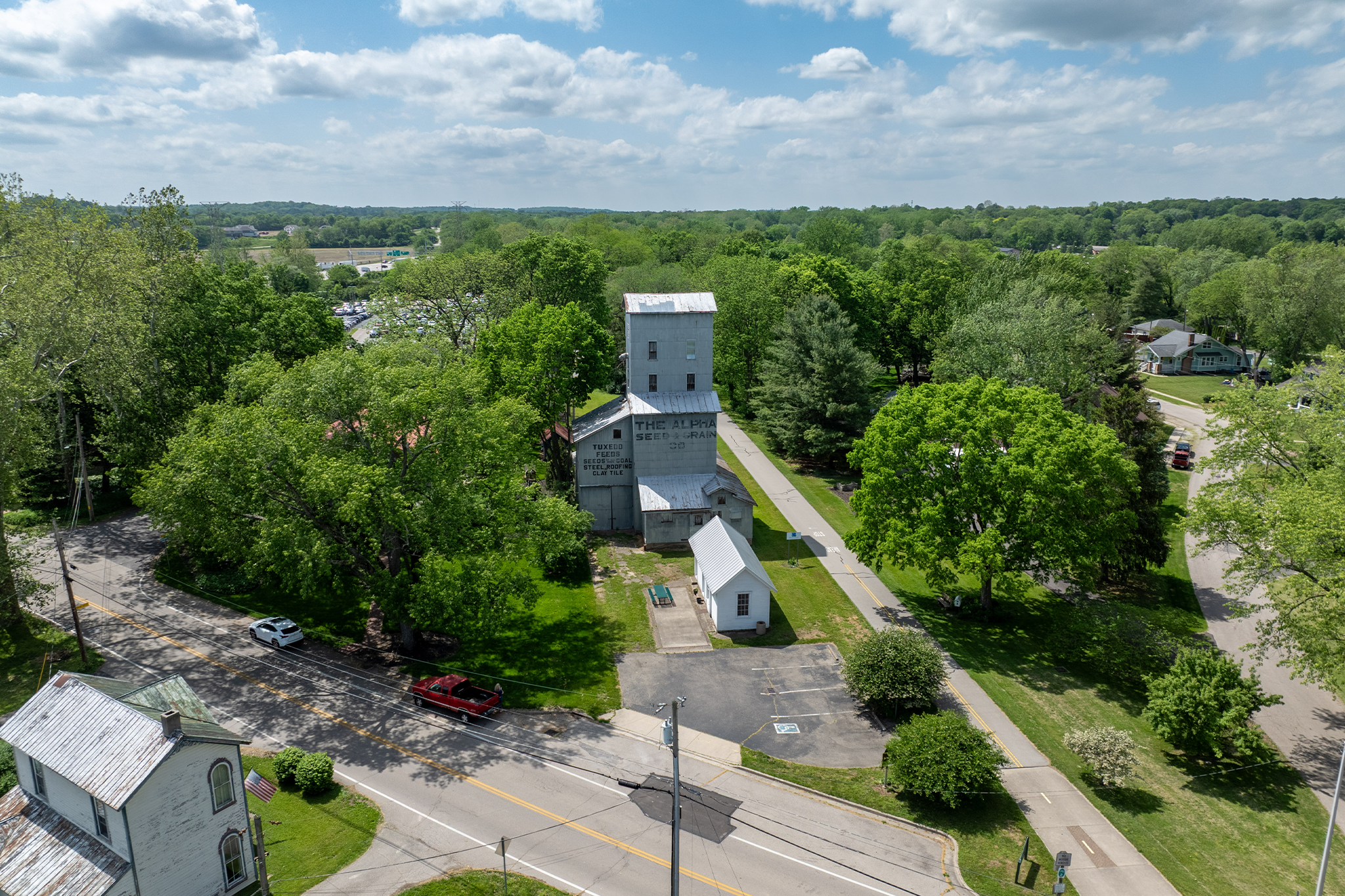 Alpha Mill building with Creekside Trail on the right and Alpha Road on the left
